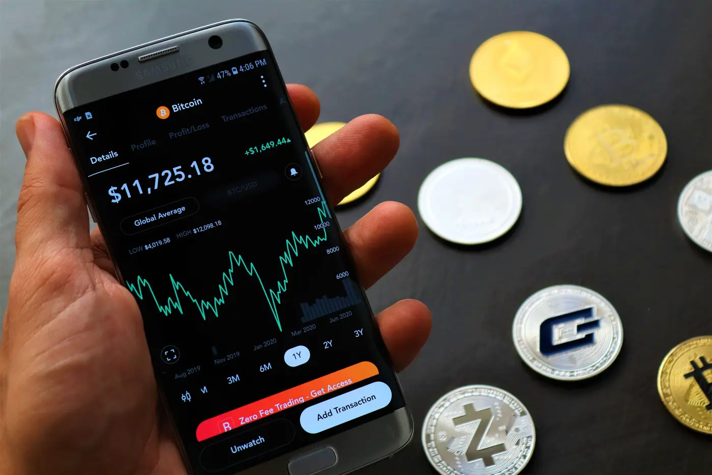 A phone showing a crypto app on a dark surface