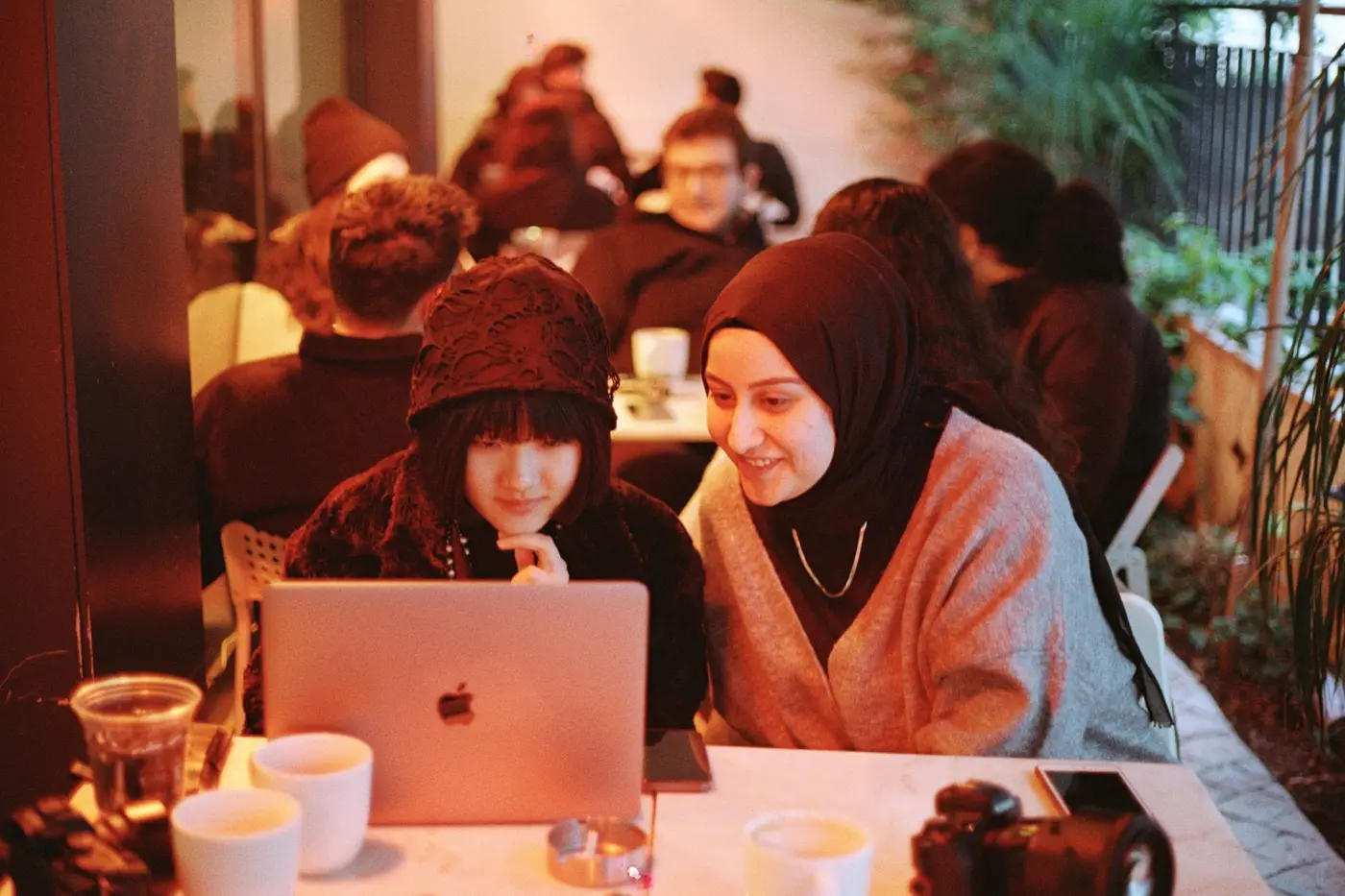 Two people talking something through over a laptop